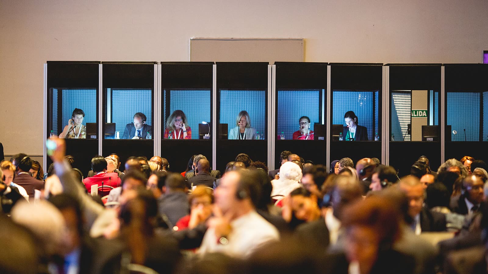 Conference interpreters working during a multilingual meeting