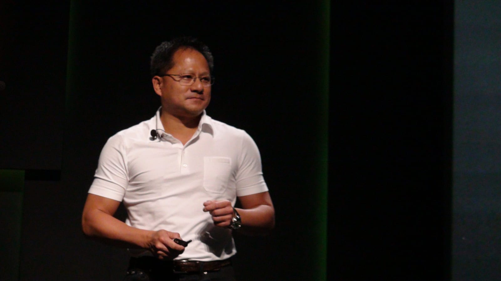 Jensen Huang on stage at Computex Taipei in 2010, in a white polo shirt against a green backdrop